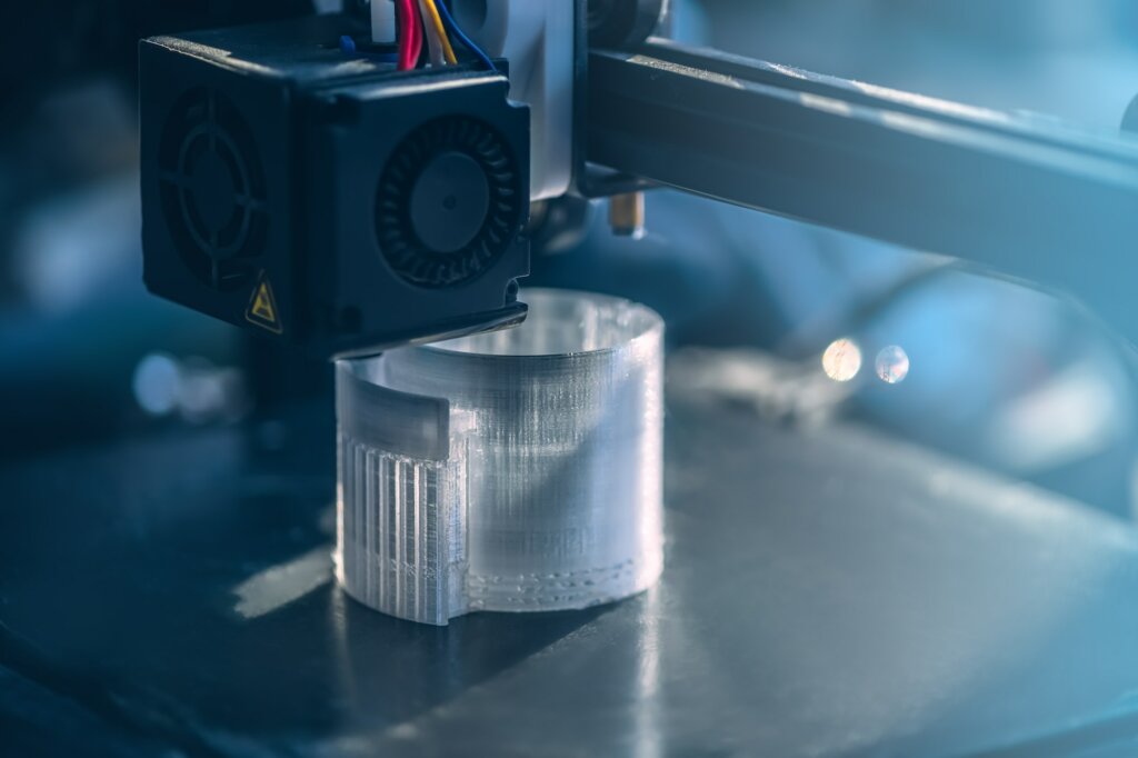 The 3D printer prints white transparent plastic model